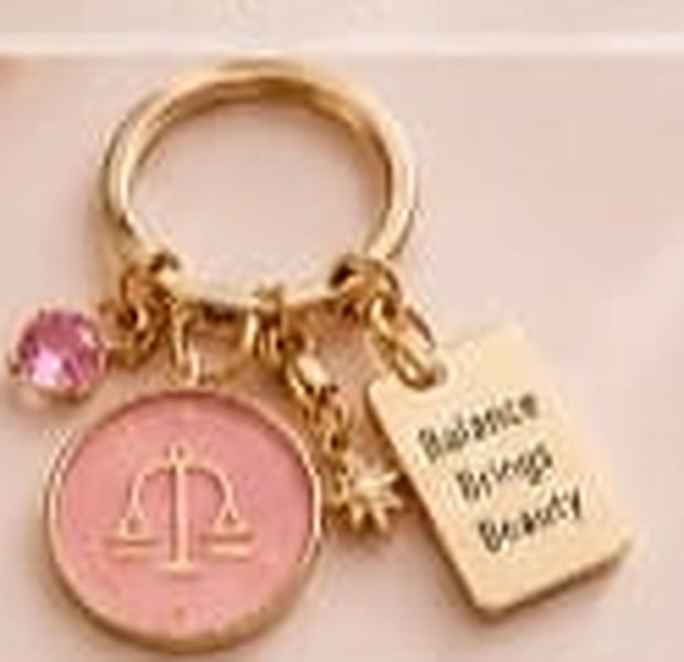 Libra zodiac keychain with a gold ring, enamel sign disc, crystal, star charm and tag reading Balance Brings Beauty